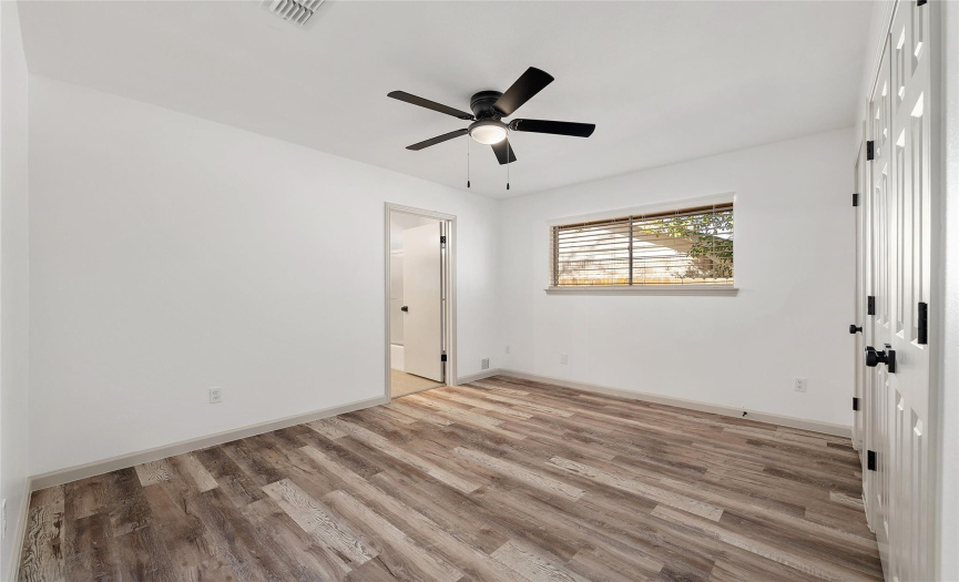 The fourth bedroom also has the beautiful flooring, a modern ceiling fan, 2.5 inch blinds, and a nice closet. All of the rooms in this home are a good size.