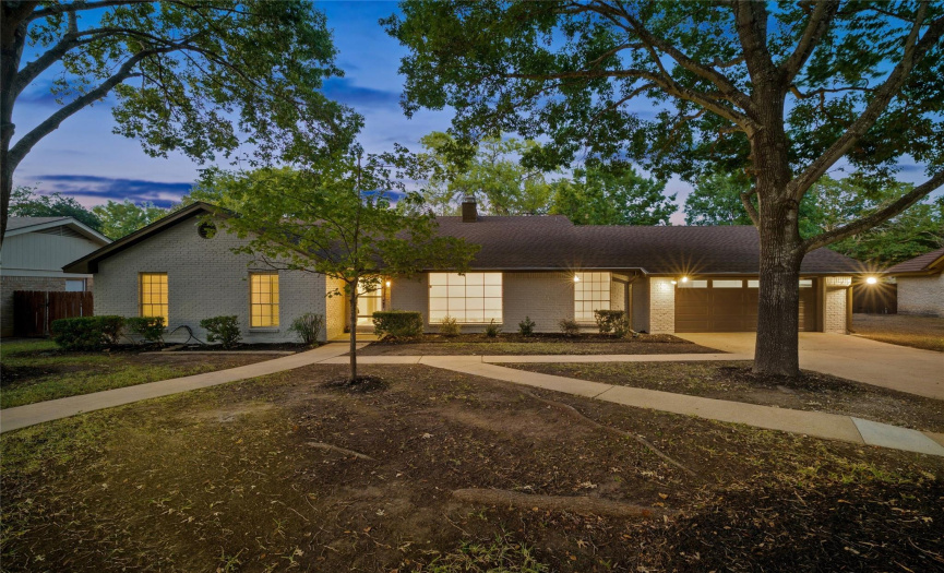 The home has great curb appeal with recently painted white brick and dark bronze trim with fresh black mulch. This home is beautiful during the day and at night.