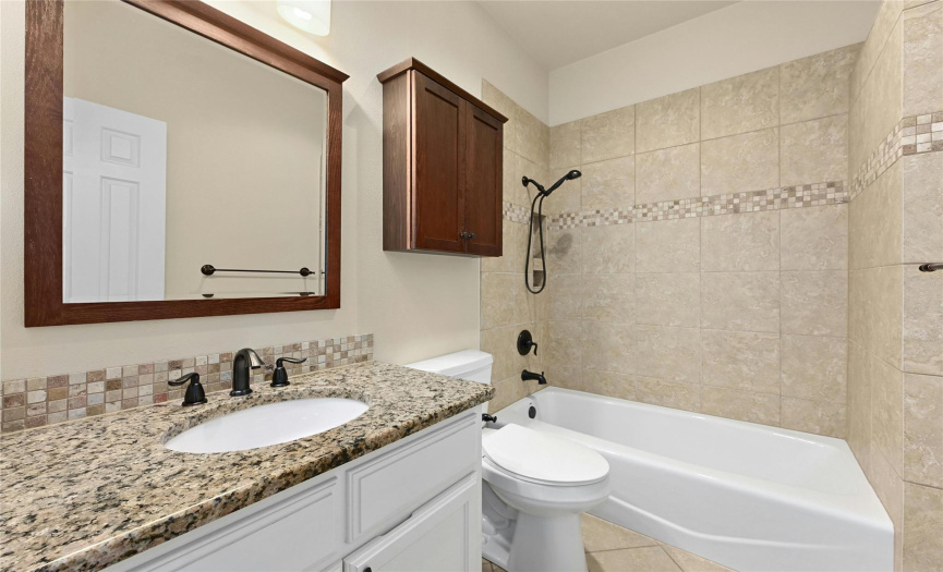 Bathroom with Granite Counters and Shower/Tub