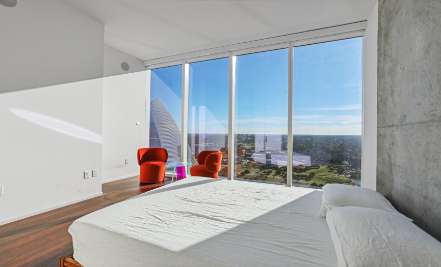Big window from bedroom with natural light and city view