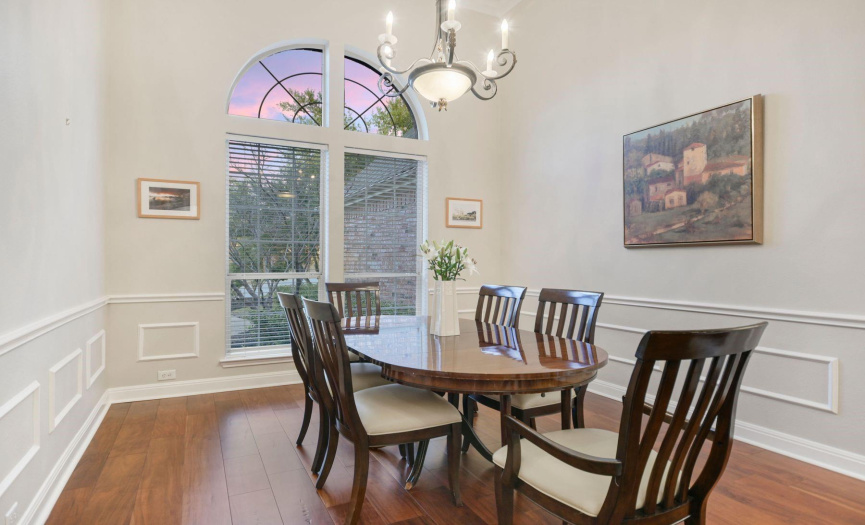 Formal dining with hardwood floors and soaring ceilings.