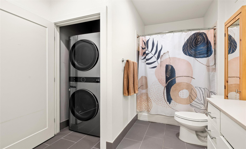 The convenient in home laundry closet is nestled away in the bathroom and provides stackable washer & dryer connections. 