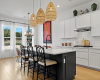 The kitchen island comes updated with custom trim work and paint plus stylish pendent fixtures overhead.