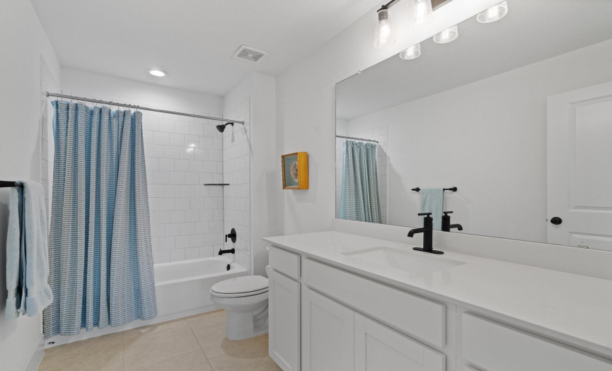 The second floor full guest bathroom provides a spacious contemporary vanity and a shower/tub combo with subway tile backsplash. Stylish fixtures and hardware in all baths. 