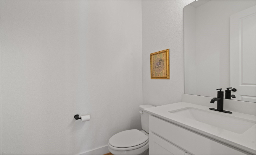 The convenient main floor powder room is situated off the Mud Room entry across from the laundry room.