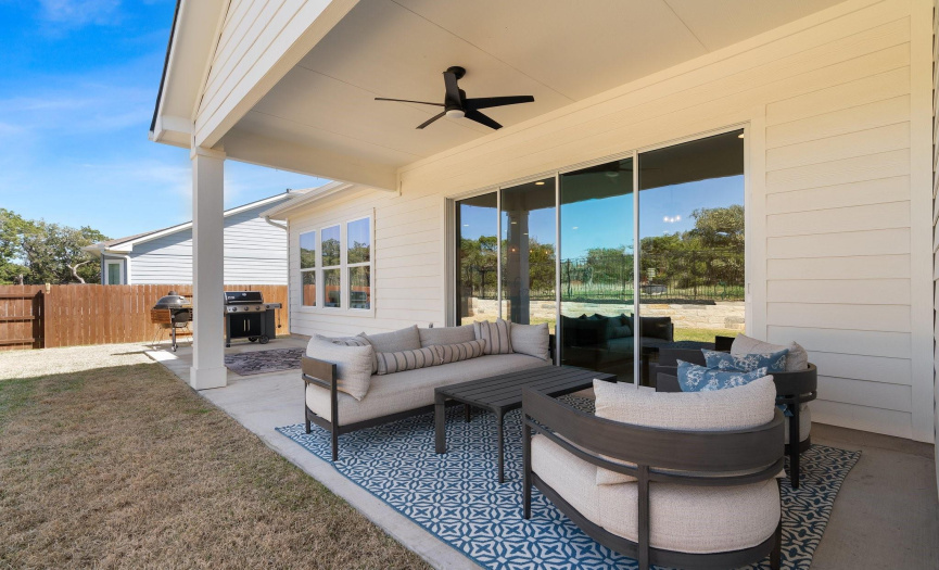 A wall of glass sliders along the living room opens your living space onto the covered back porch where you can kick back and relax under the breeze of the overhead fan and take in the peaceful greenbelt views. 