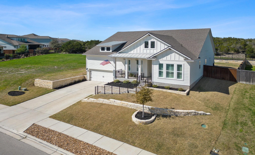 Excellent curb appeal with refined architectural design, a covered front porch, professional updated landscaping including elegant stonework, and a 2.5-car garage with workshop potential and storage galore.