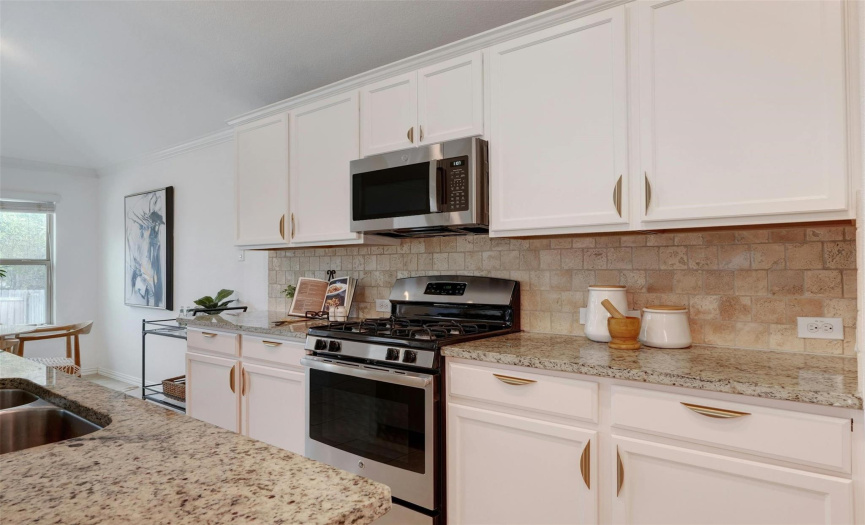 The home chef will love all of the counter space and cabinetry storage. Well maintained cabinetry features stylish updated hardware. 