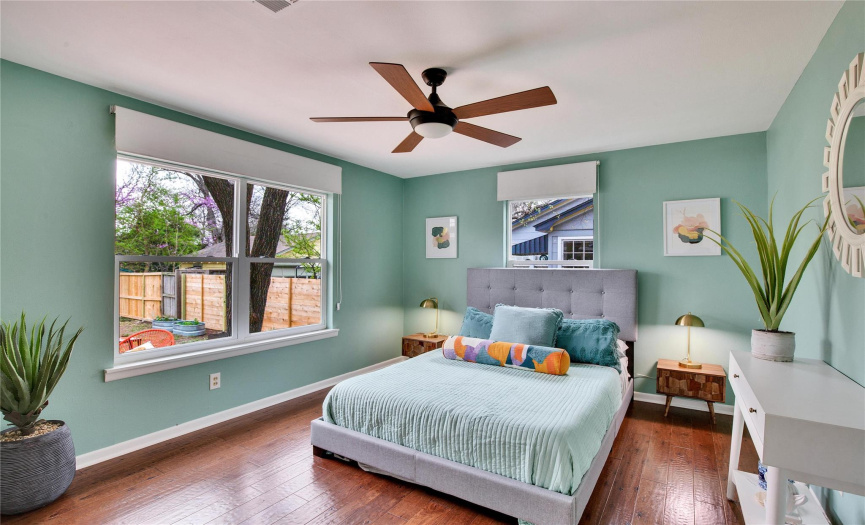 The primary bedroom offers plenty of space to retreat in comfort at the end of the day, and two large windows offer a picturesque view of the backyard. 