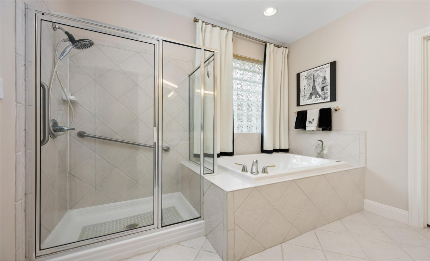 Primary shower, garden tub, and glass block window for light but also privacy.