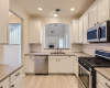 The kitchen boasts the latest white cabinetry that perfectly complements the modern granite countertops.