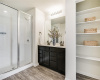This ensuite private primary bathroom has a large walk-in shower, double vanity and storage for linens and the necessary items you use every day.