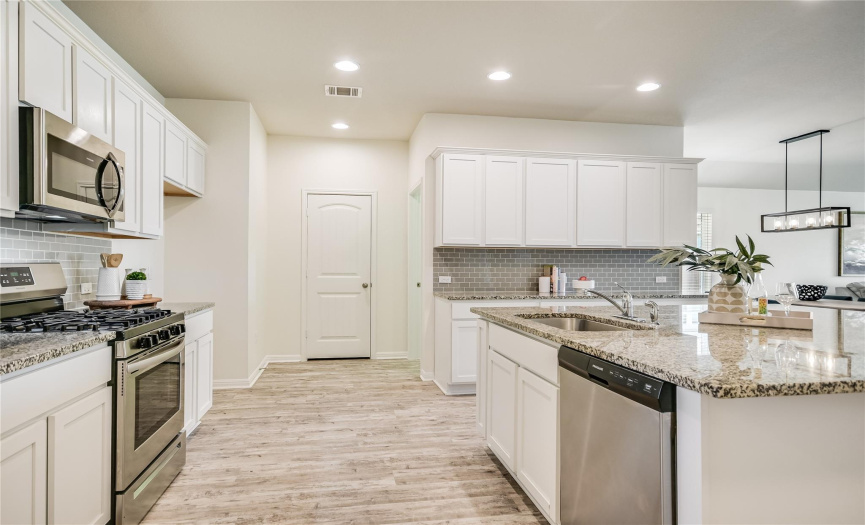 Plenty of room for the Family Chef to have lots of help with meal preparation, serving and cleanup. Stainless steel appliances, vinyl plank flooring, task lighting, lots of counter/cabinet space and drawer storage for all those 