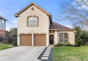 Beautiful, white, chopped stone home with soldier-brick, manicured yard and greenbelt privacy.
