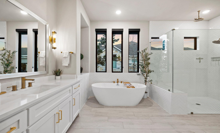 Indulge in the luxurious spa-like atmosphere of the primary ensuite bath, complete with a standalone soaking tub, a spacious walk-in shower, and separate vanities, offering ample space for relaxation.