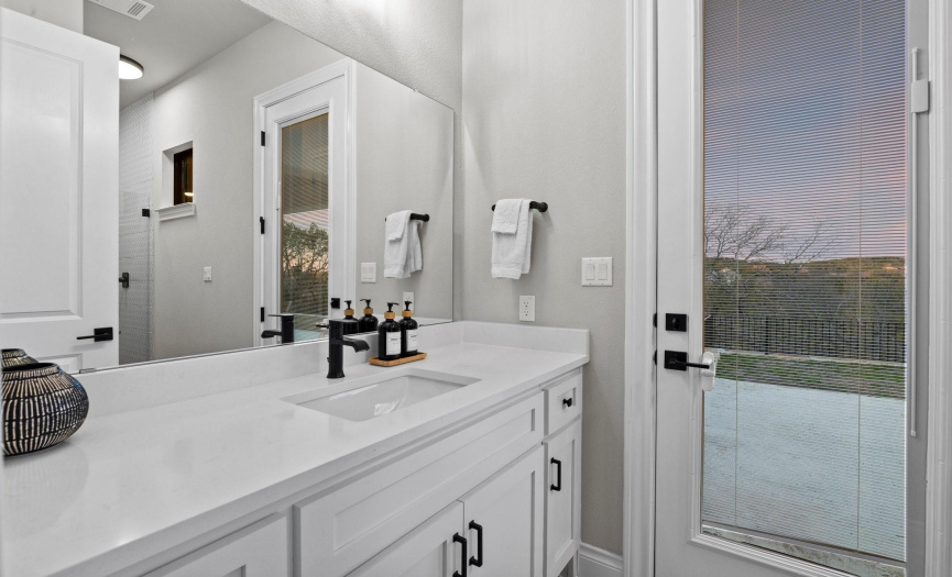 The main floor guest suite features a full ensuite bath, providing convenience and privacy for guests. Offers direct access to the stunning backyard.