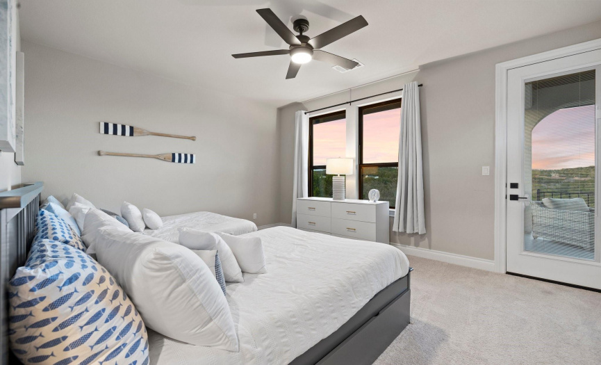 The spacious 2nd-floor bedroom is one of three and features a balcony, providing a private outdoor retreat with beautiful views.