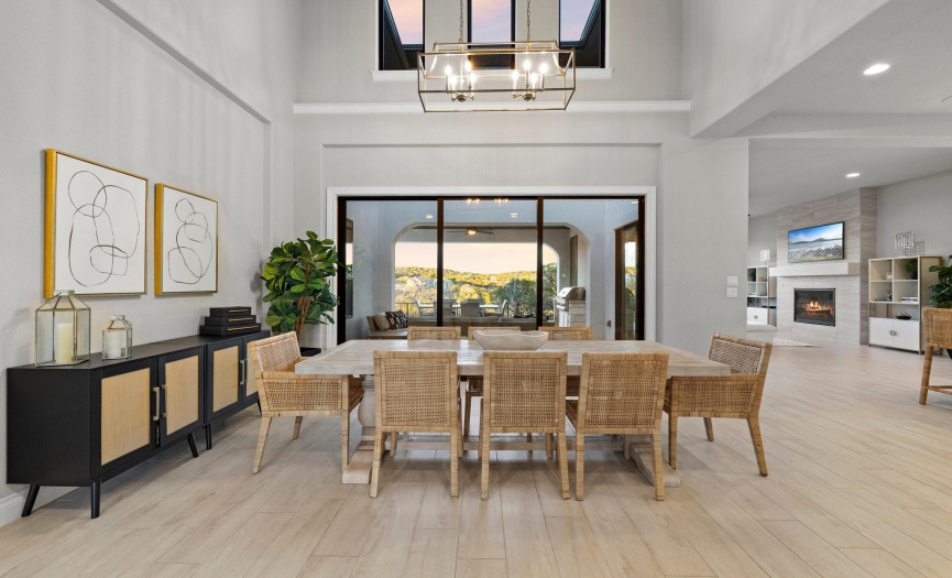 Another angle of the captivating two-story dining area adorned with art niches to showcase your favorite pieces, and framed by a sleek black slider door.