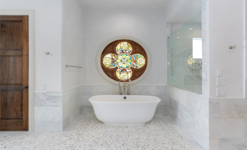 Soaking tub perfectly placed under the Italian stain-glass window...beautiful!