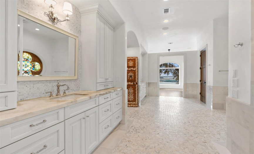 The spa-like primary bathroom is beautifully appointed. 