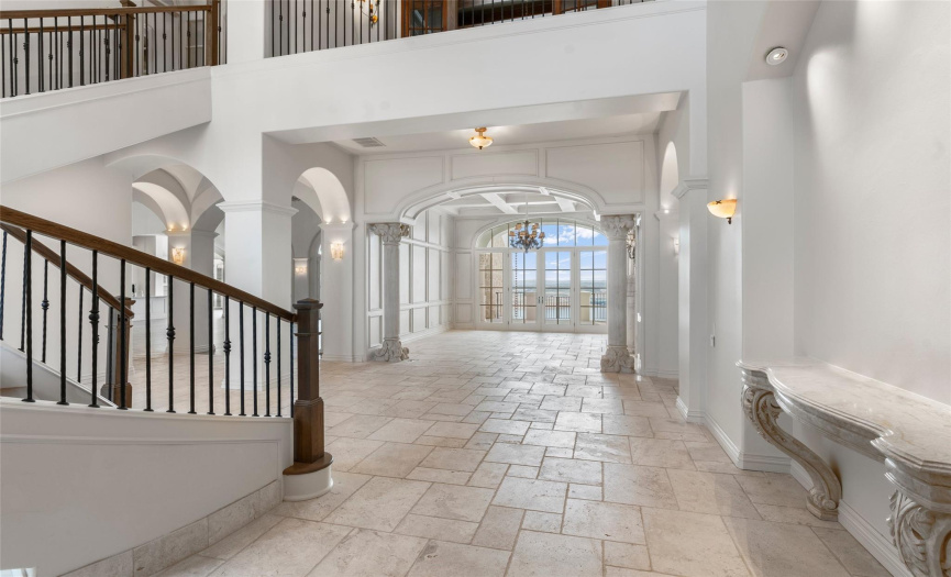 Grand Foyer with view to the Formal Living room and lake views beyond
