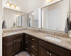 Primary bathroom includes granite countertops and a lot of storage