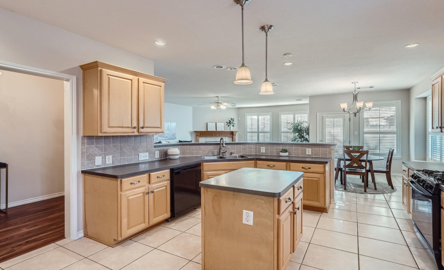 Spacious Kitchen with Island and dimmable pendant lighting above island and breakfast bar