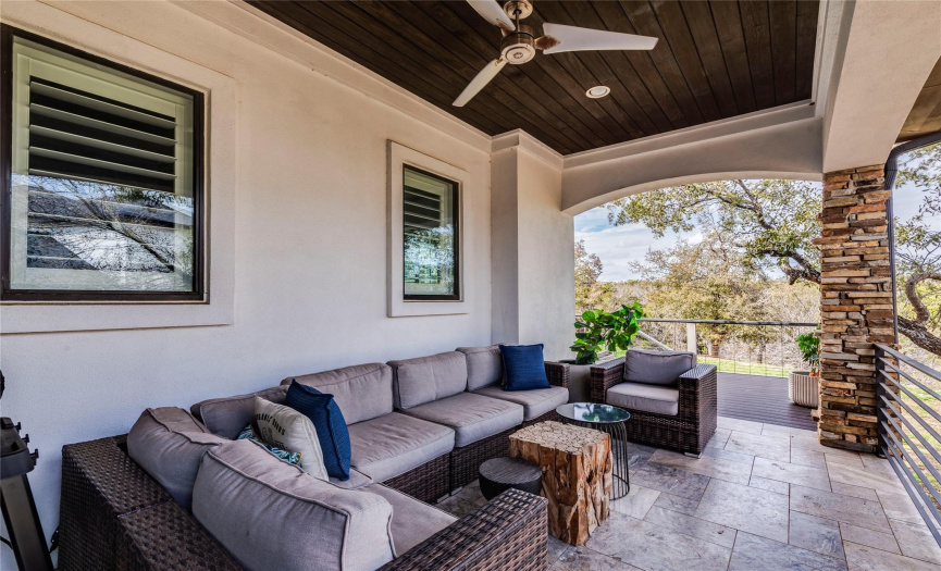 covered back patio overlooking the private backyard perfect for unwinding with a glass of wine 