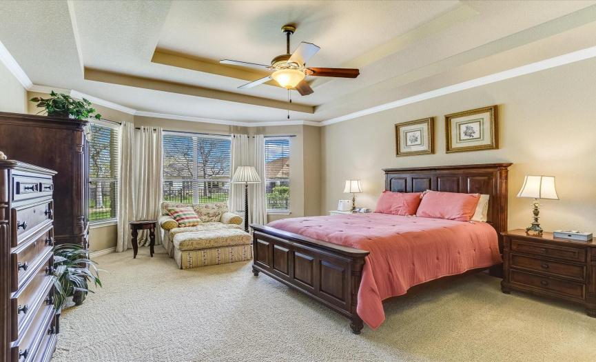 Elegant master bedroom with double tray ceilings.