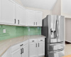 Quartzite counters provide the foundation for green sea glass tiles. Refrigerator can vase.