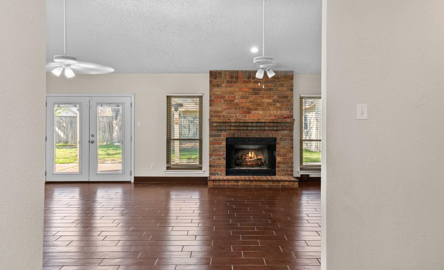 Your first step into the entry gives you a peek at the beautiful fireplace and look through to the backyard.