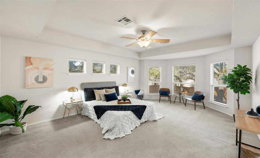 Retreat to the main floor primary bedroom with additional seating or reading nook. 