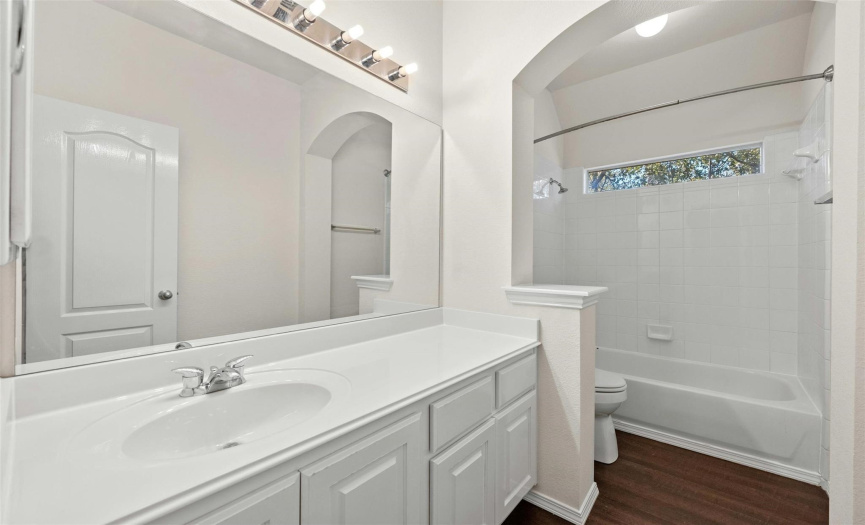 The guest bathroom is conveniently located with an extended vanity and tub/shower combo.