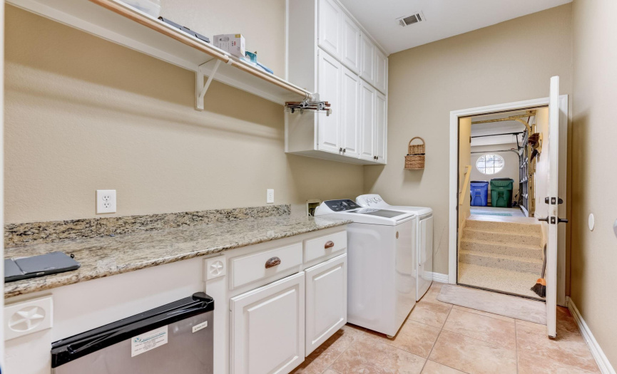 Super-sized laundry room with granite counter and loads of cabinet storage