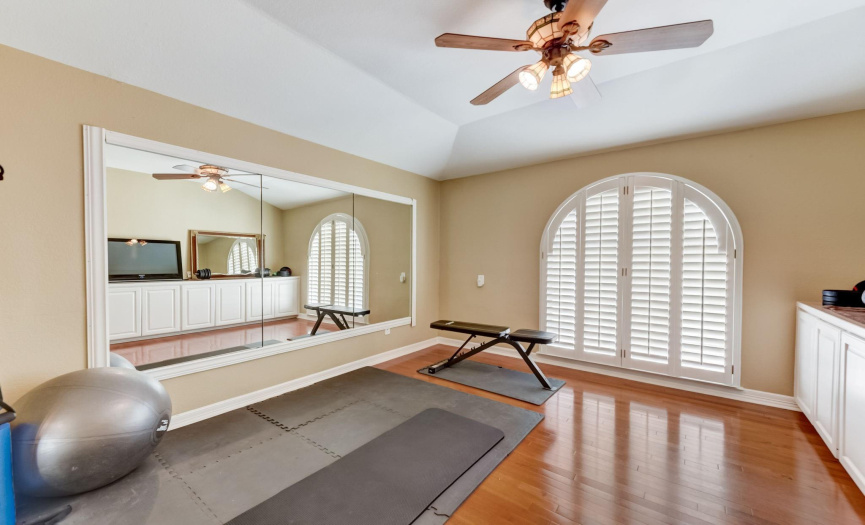 Another flex room currently used as an exercise room, also features built-in cabinets