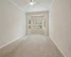 Main Bedroom is comfortably carpeted with bay window, 10' ceilings and crown molding.