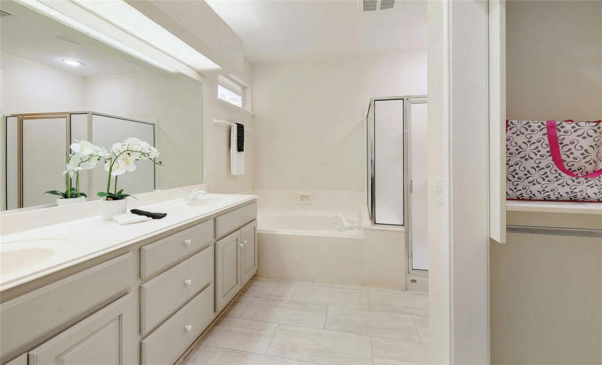 Main Bath with dual vanity, garden tub and standup shower.