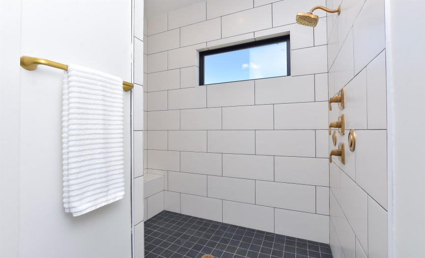 Primary walk in shower with multiple shower heads