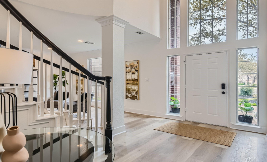 Welcome home as you enter the 2 story foyer with Palladium upper window, column with crown molding and sweeping staircase