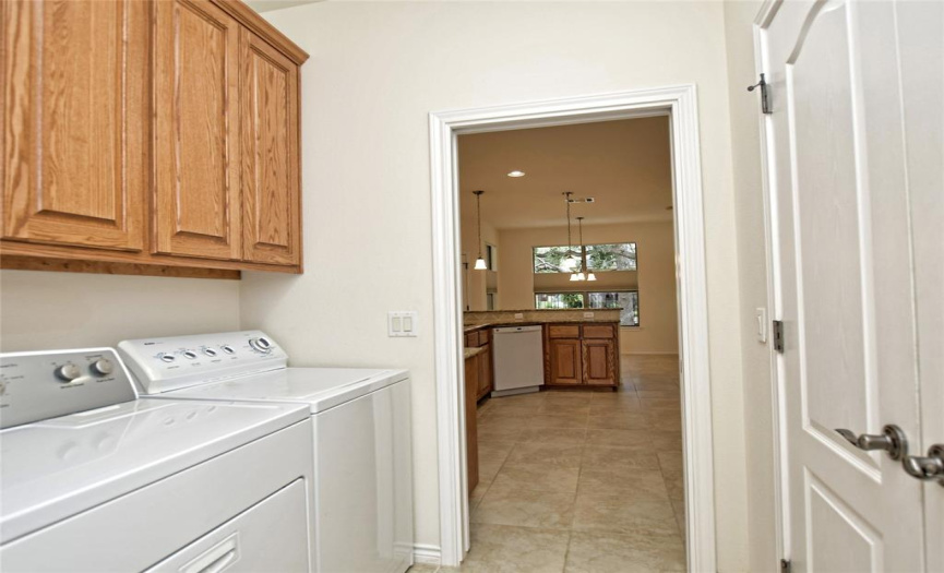 Laundry room is adjacent to the kitchen. The double doors on the right are the pantry.