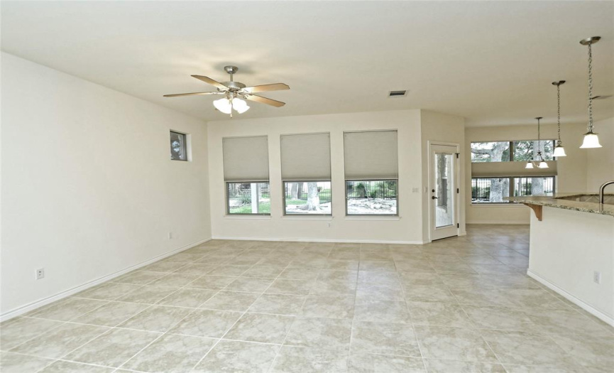 Enter into a large living area that is open to the kitchen and dining. 
