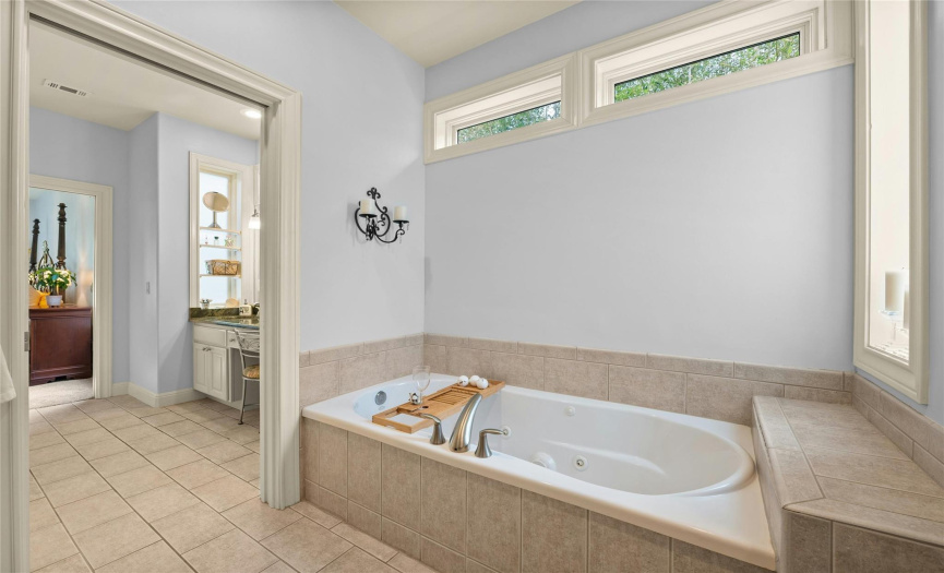 A primary bath with the ultimate in privacy. Another pocket door allows for quiet time while enjoying a long spa bath.