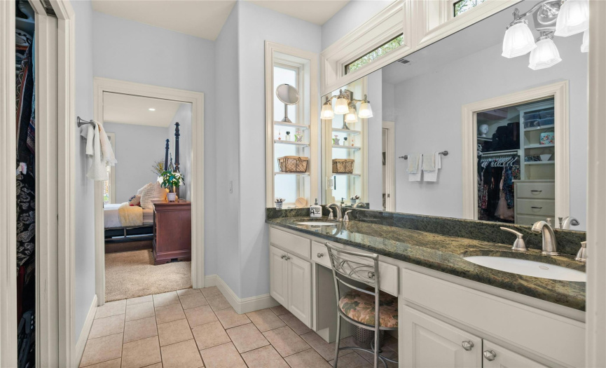 Double vanity with clerestory windows above the mirror adds more natural light. A walk-in closet will not disappoint!