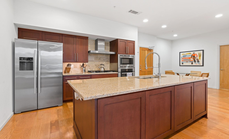 Well-equipped kitchen features built-in stainless Bosch appliances, including a 5-burner gas cooktop.
