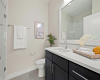 The elegantly appointed primary bathroom offers a walk-in shower.