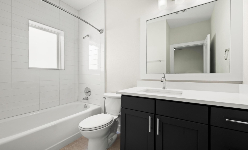 The second bedroom offers an ensuite bathroom with a shower/tub combo.