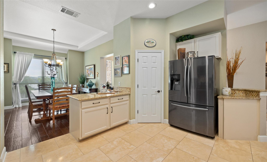 There is no shortage of counter space! Notice how the kitchen and dining are divided by a serving area. 
