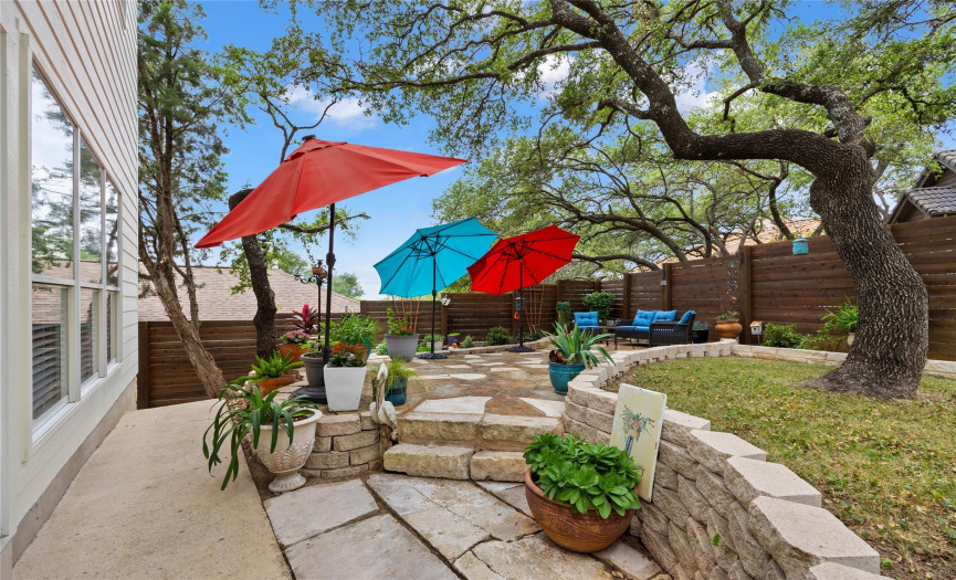 Mature oak trees add shade to this lovely backyard!