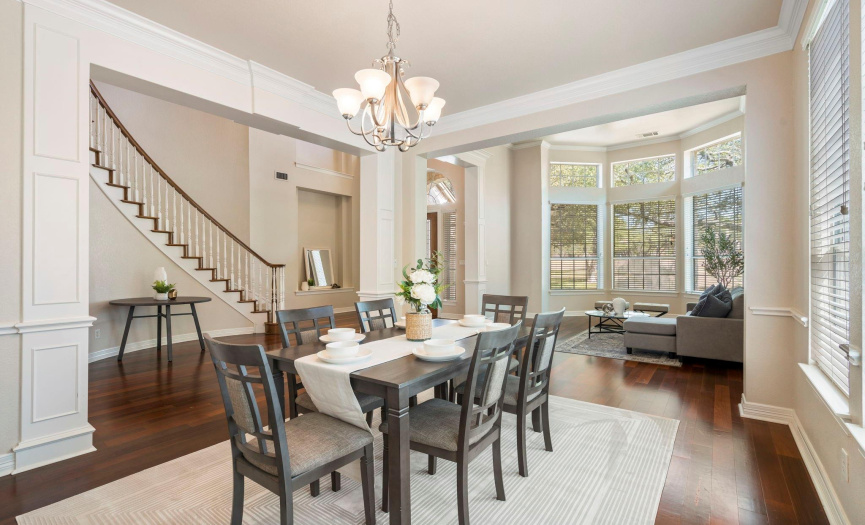 Grand formal dining area with wood floors throughout. 
