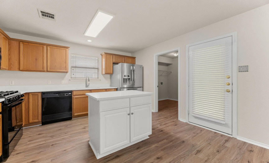 The laundry room is located off the kitchen, and leads to the garage, and the patio door is also located off the kitchen.